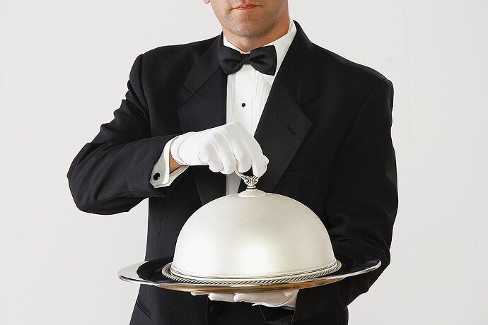 00649084-Butler-holding-a-domed-silver-serving-tray